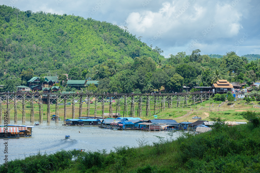 Fototapeta premium The old bridge made from wood at Sangkha buri in the evening time. Sangkhla-Buri, is in Kanchanaburi province of Thailand.