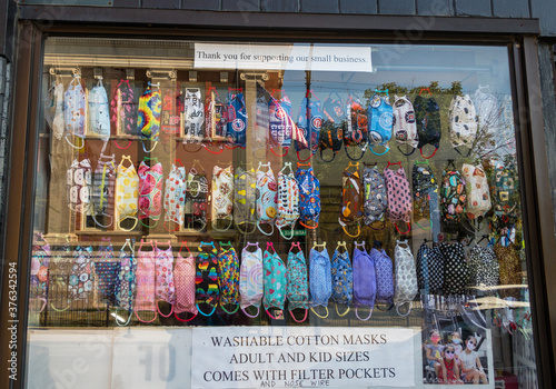 storefront window with PPE face masks for sale