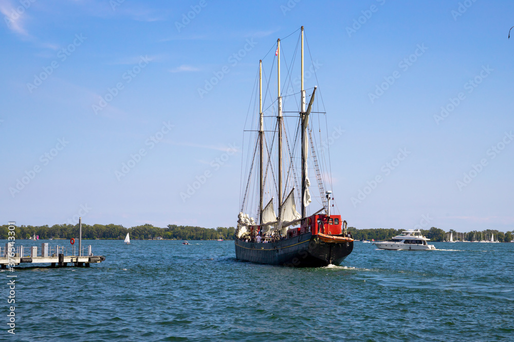 Vintage sail ship departs from the port Toronto. Untitled