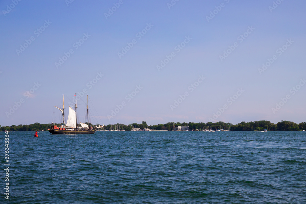 Vintage sail ship departs from the port Toronto. Untitled