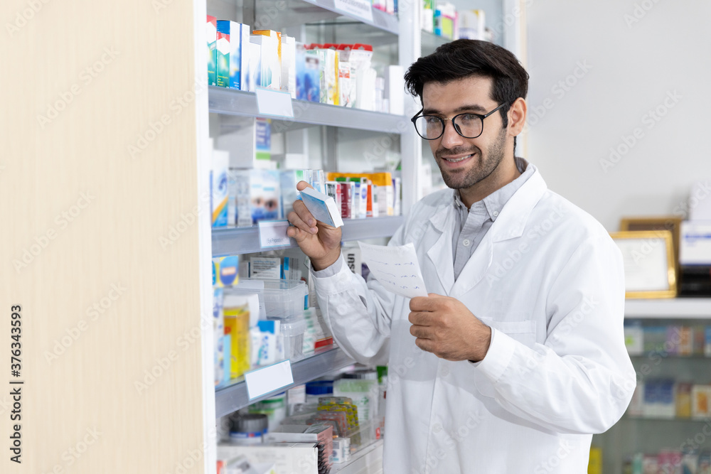 Middle eastern male pharmacist selling medications to patient in modern pharmacy prescription Middle eastern male pharmacist selling medications to patient in modern pharmacy prescription