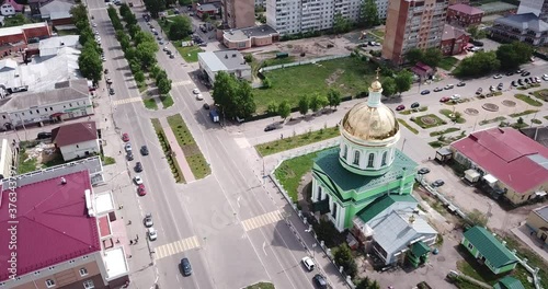 View from drone of Ozyory cityscape with golden dome of Holy Trinity Church on spring day, Russia photo