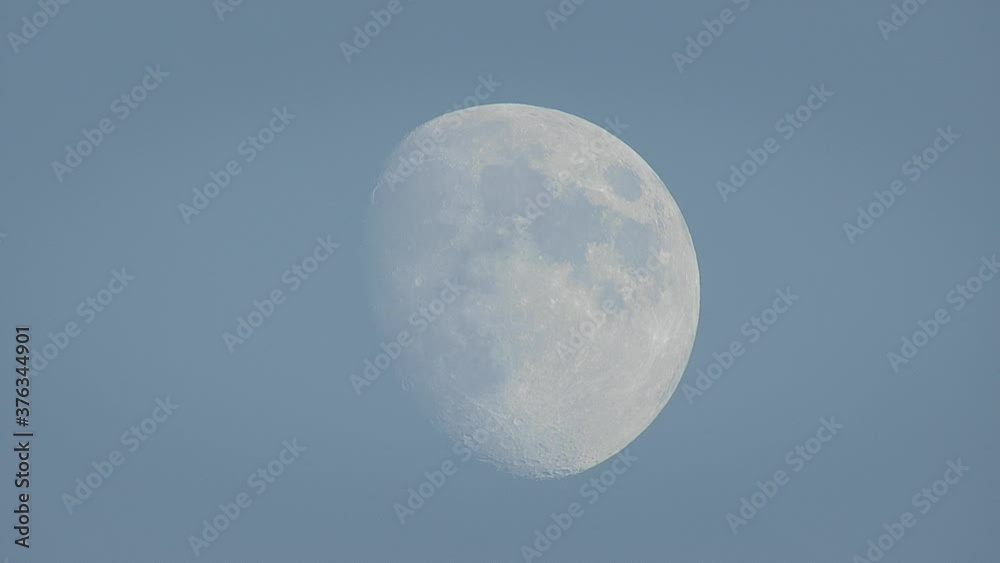 Early evening moon against a blue sky Early evening moon against a blue sky