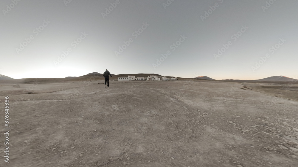 Caucasian Male Walks in Uyuni Salt Flat at Sunset