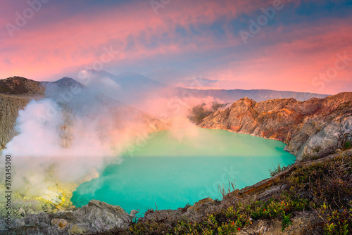 Panorama landscape view of Kawah Ijen at sunrise sky. The most famous tourist attraction in Indonesia.
