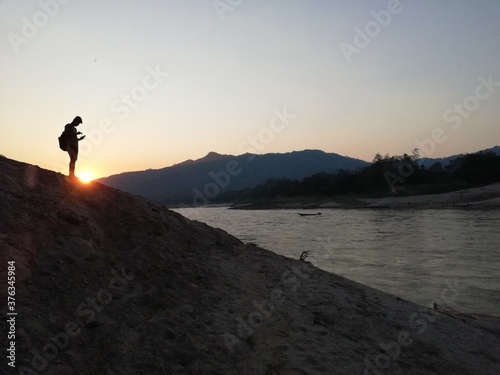 silhouette of a man on a mountain