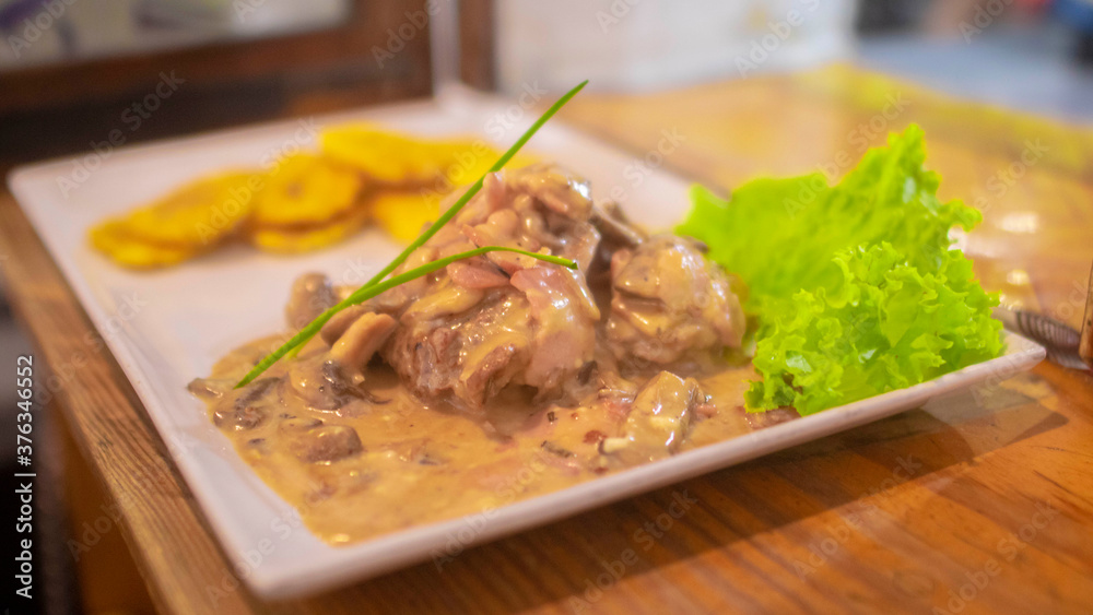 Filete de res en salsa boscaiola con tostones