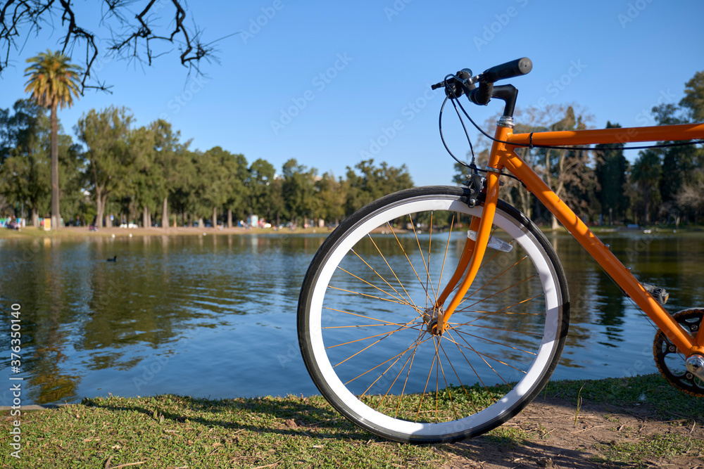 Orange bicycle next to a lake in Buenos Aires, Argentina Orange bicycle next to a lake in Buenos Aires, Argentina