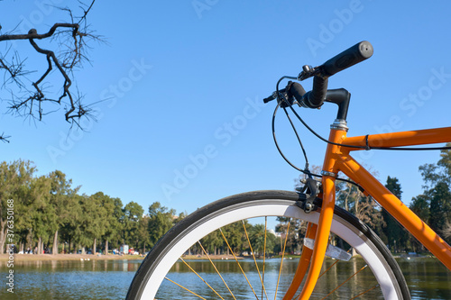 Orange bicycle next to a lake in Buenos Aires, Argentina © Carolina Jaramillo