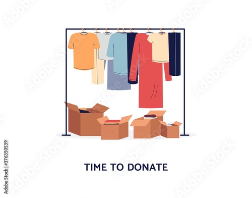Clothes donation concept - clothing rack and cardboard boxes