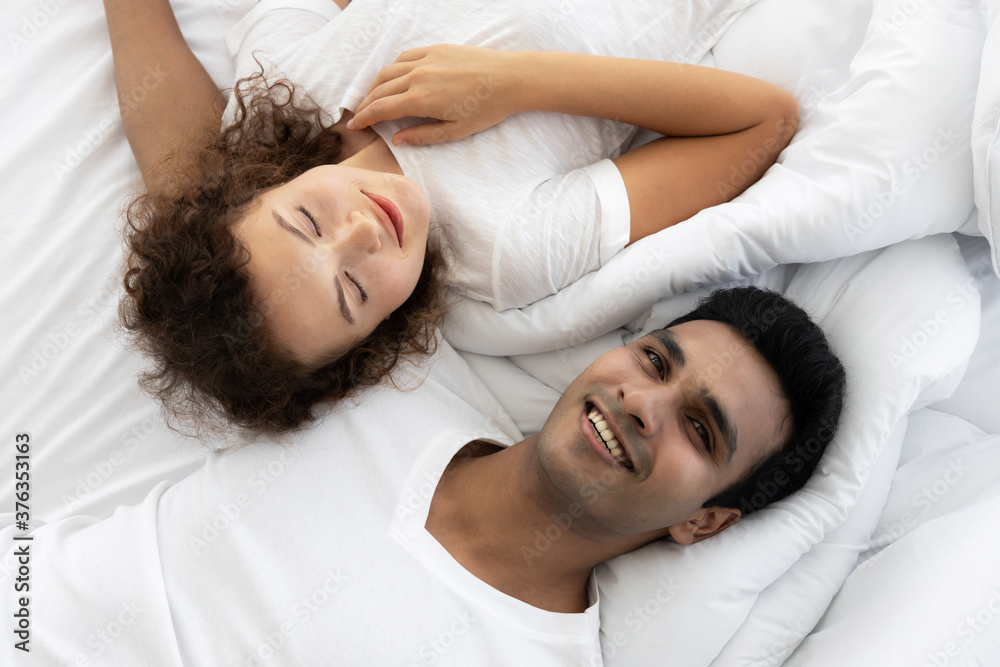 Top view of romance couple lying on the bed in bedroom Top view of romance couple lying on the bed in bedroom