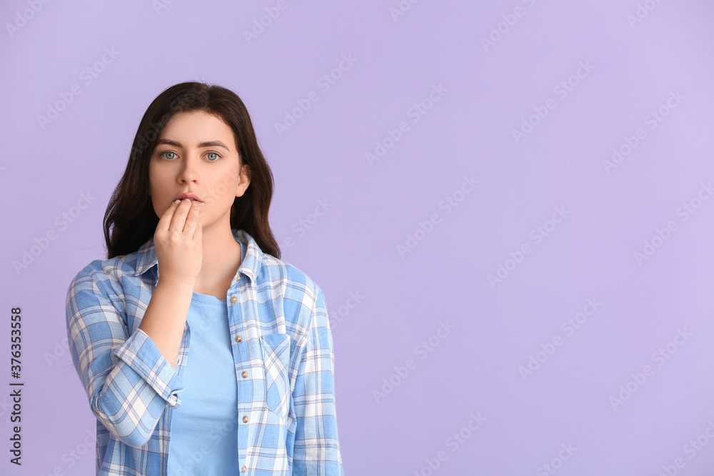 Young deaf mute woman using sign language on color background Young deaf mute woman using sign language on color background