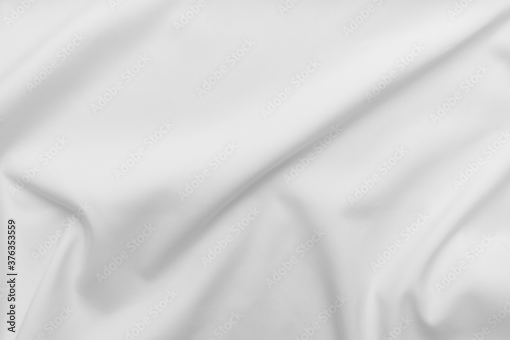 Abstract white fabric texture background. Cloth soft wave. Creases of satin, silk, and cotton.	