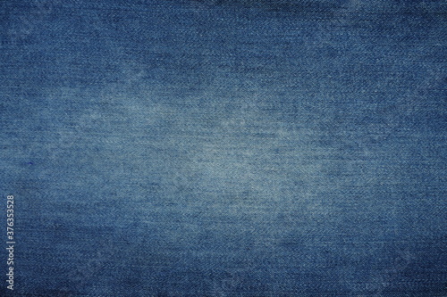 Top view of blue jeans fabric with white stains for background and decoration Textile texture and rough surface of jeans
