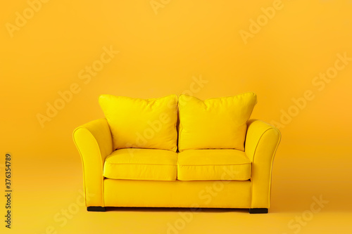 Stylish sofa on color background