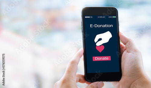 e-donation concept.close-up of man hands make an online donate via mobile phone