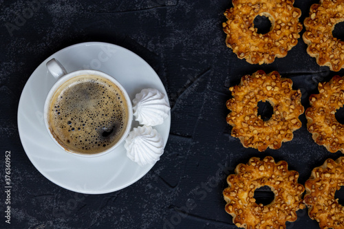  Cup of americano with cookies top view. Food background