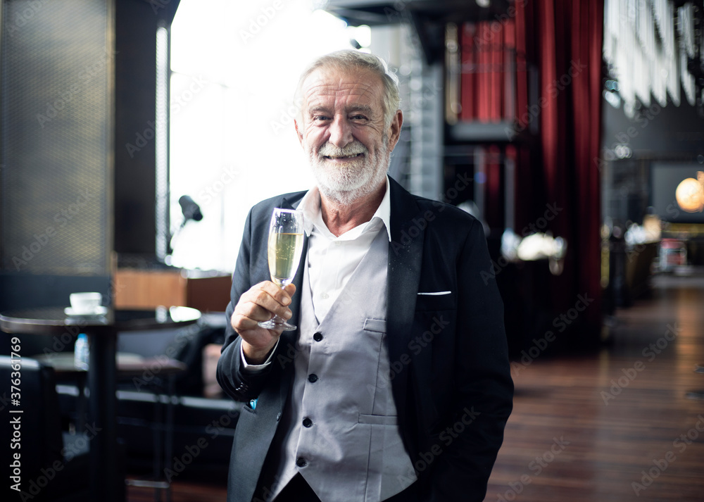 Elder senior chief executive officer with a glass of champagne for success at resterunt. Elder senior chief executive officer with a glass of champagne for success at resterunt.
