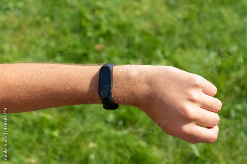 Close-up Of A Person Hand Wearing Smart Watch. fitness man using smart watch. © IKvyatkovskaya