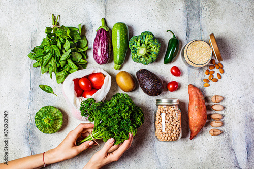 Healthy plant based food flat lay. Fresh vegetables, fruits, nuts, quinoa, chickpeas on white background. Zero waste, vegan food, eco friendly concept.