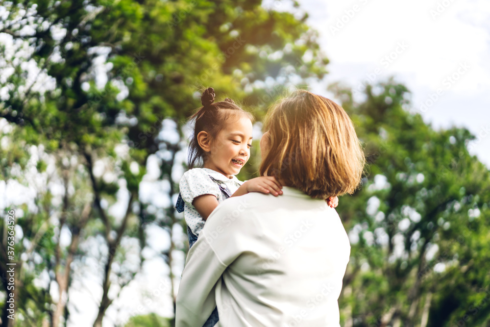 Portrait of happy grandmother and little cute girl enjoy relax together in summer park.Family and togetherness Portrait of happy grandmother and little cute girl enjoy relax together in summer park.Family and togetherness