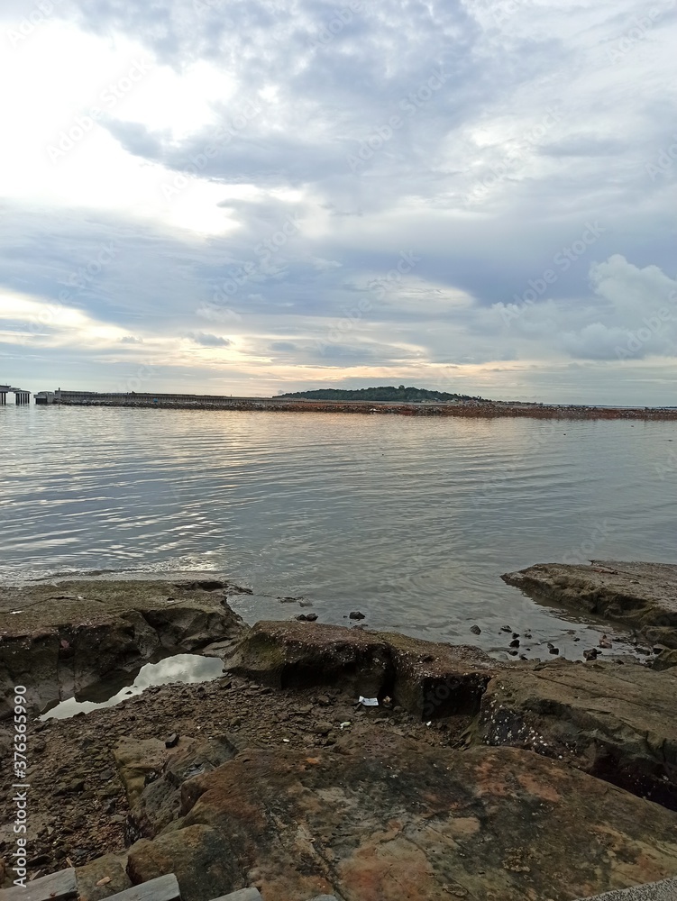 Beach view at sunset with cloudy sky Beach view at sunset with cloudy sky