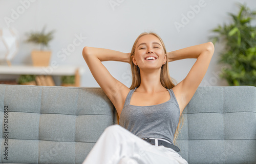 woman resting on sofa at home © Konstantin Yuganov