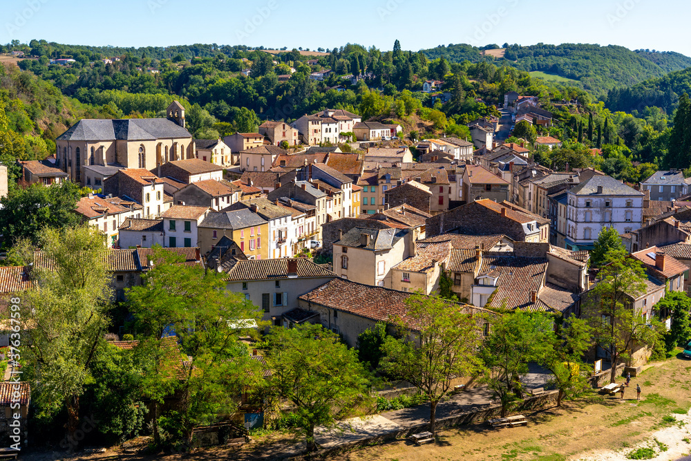 Beautiful top view of the French village of Laguepie. Old catholic cathedral. Orange tiled roofs. 