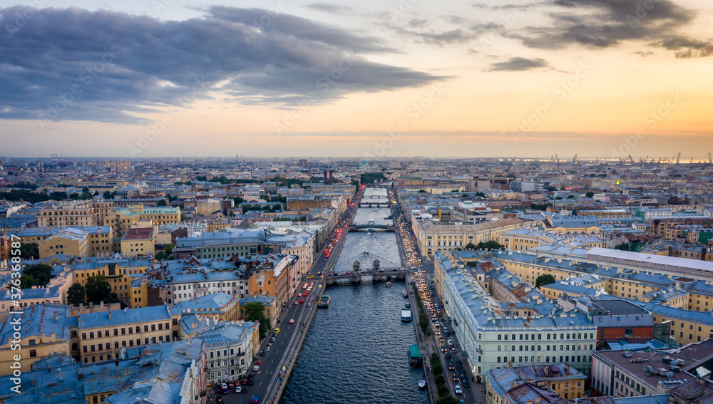 Fototapeta premium Aerial view of the city at sunset in Saint Petersburg, Panorama of the Fontanka River and the bridges across it. View of the city from above. Cities of Russia. Petersburg in the summer.