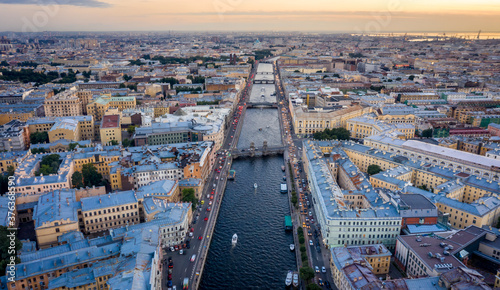 Aerial view of the city at sunset in Saint Petersburg, Panorama of the Fontanka River and the bridges across it. View of the city from above. Cities of Russia. Petersburg in the summer. © Alexey Oblov