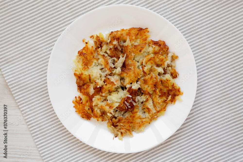 Homemade Fried Hashbrowns on a white plate, top view. Flat lay, overhead, from above.
