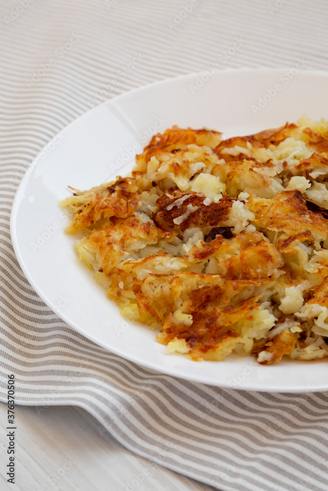 Homemade Fried Hashbrowns on a white plate, low angle view. Homemade Fried Hashbrowns on a white plate, low angle view.