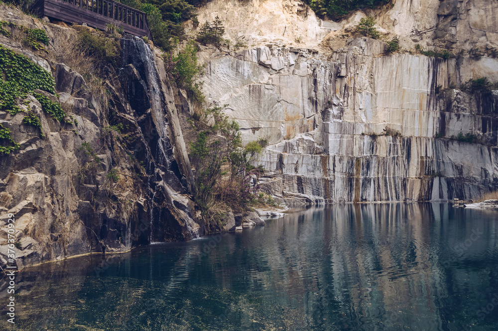 iew of small waterfall and turquoise lake