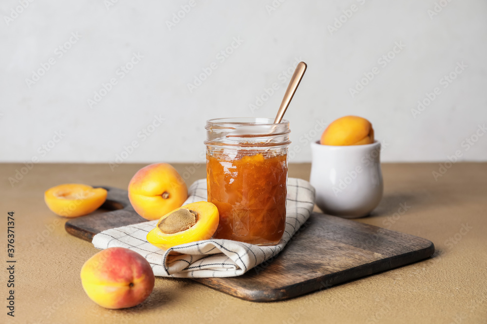 Jar of tasty apricot jam on table Jar of tasty apricot jam on table