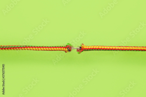 Фотография Frayed rope on color background