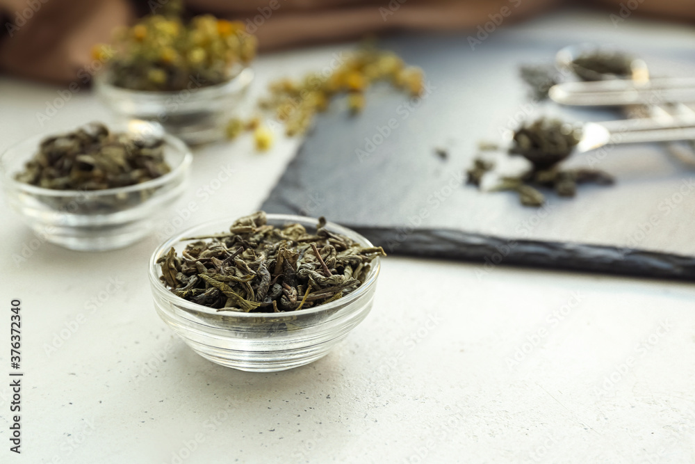 Bowl with dry tea leaves on table Bowl with dry tea leaves on table