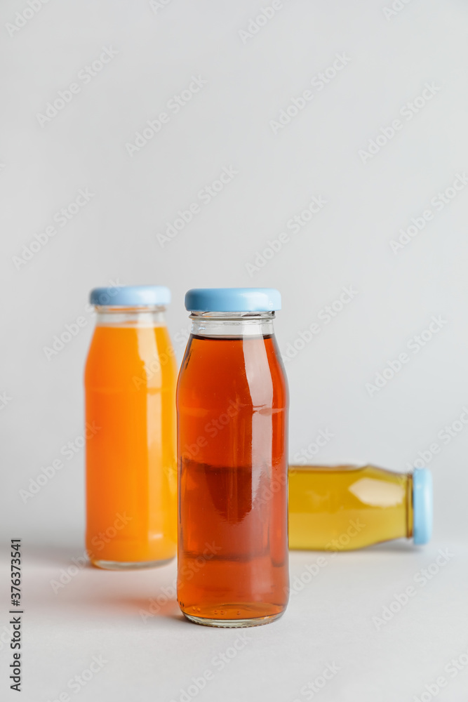 Bottles of juices on light background Bottles of juices on light background