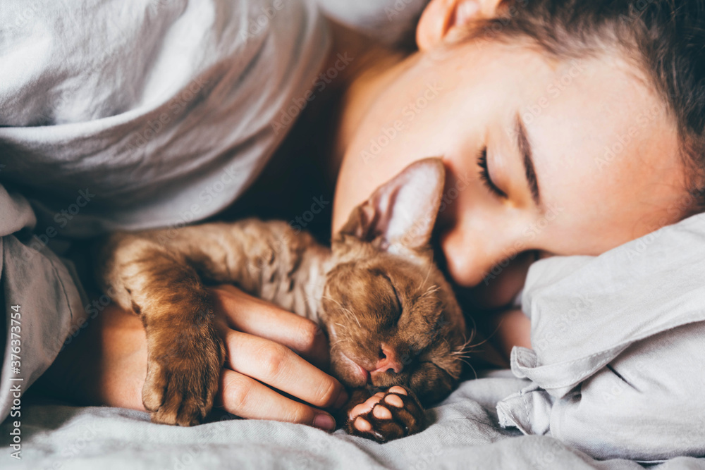 Girl sleeping with a cat on bed. Girl sleeping with a cat on bed.