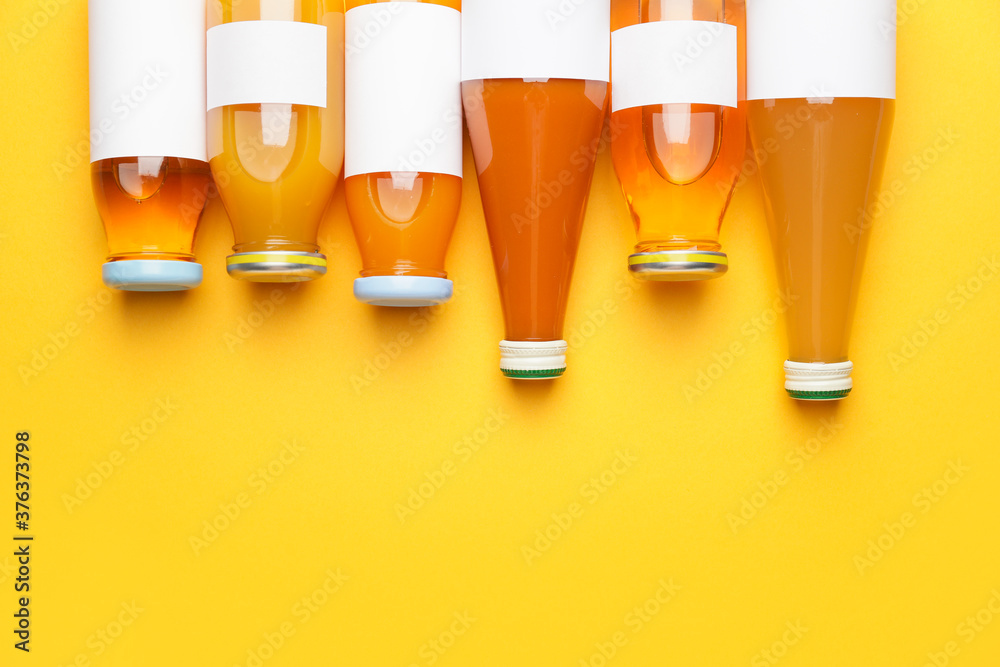 Bottles of juices on color background Bottles of juices on color background