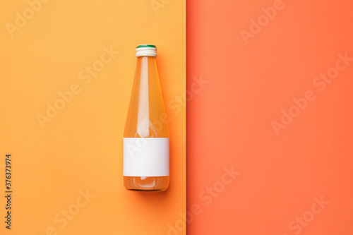Bottle of juice on color ba...
