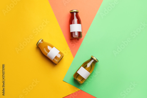 Billede på lærred Bottles of juices on color background