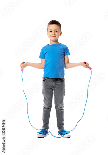 Cute little boy jumping rop...