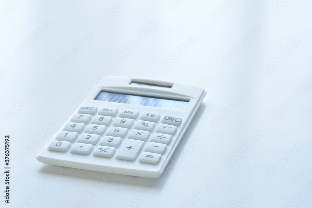 Calculator on a white desk Calculator on a white desk