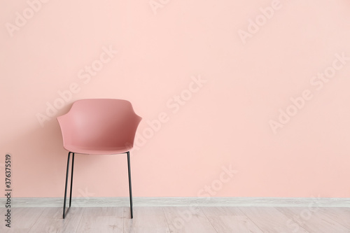 Modern chair near color wall