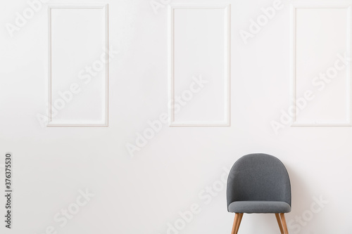 Fototapeta Naklejka Na Ścianę i Meble -  Modern chair near light wall