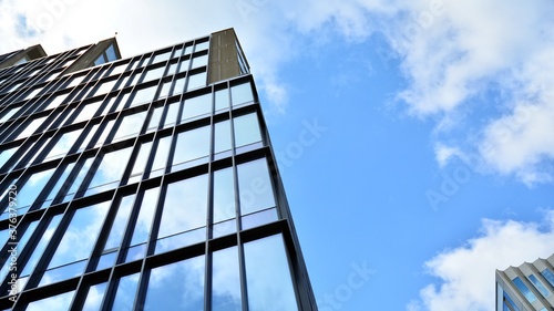 Office building, blue glass wall reflection detail. Modern office building and clear sky background. 