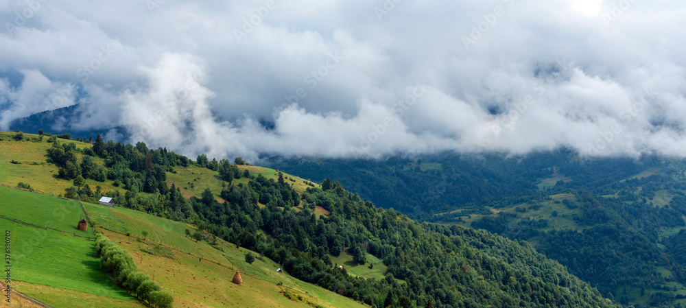 Majestic view on beautiful fog and cloud mountains in mist landscape.