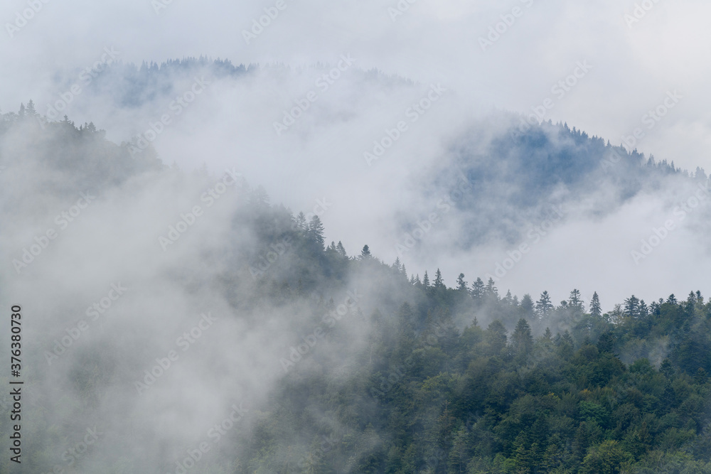 Majestic view on beautiful fog and cloud mountains in mist landscape.