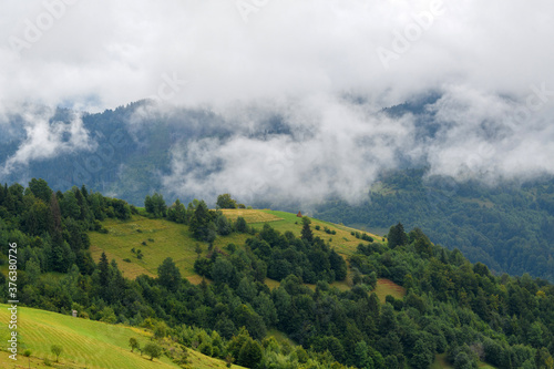 Majestic view on beautiful fog and cloud mountains in mist landscape.