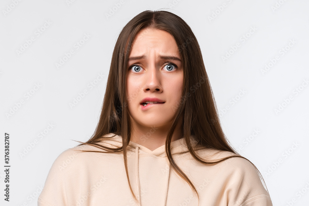 Portrait of the scared woman with long chestnut hair